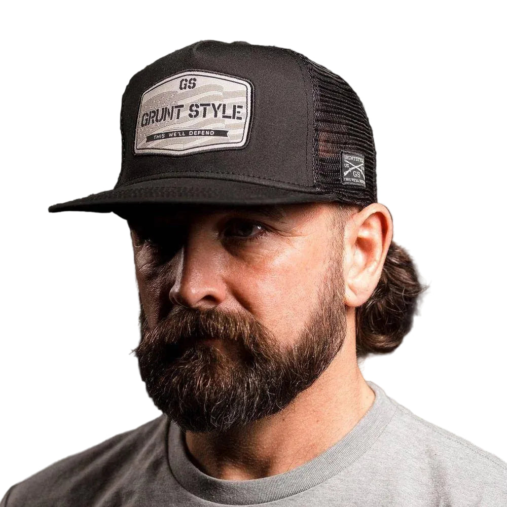 Man wearing a black cap with 'Grant Style' logo on a dark background