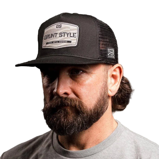Man wearing a black cap with 'Grant Style' logo on a dark background