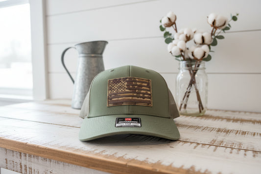 Green cap with American flag patch on a white surface