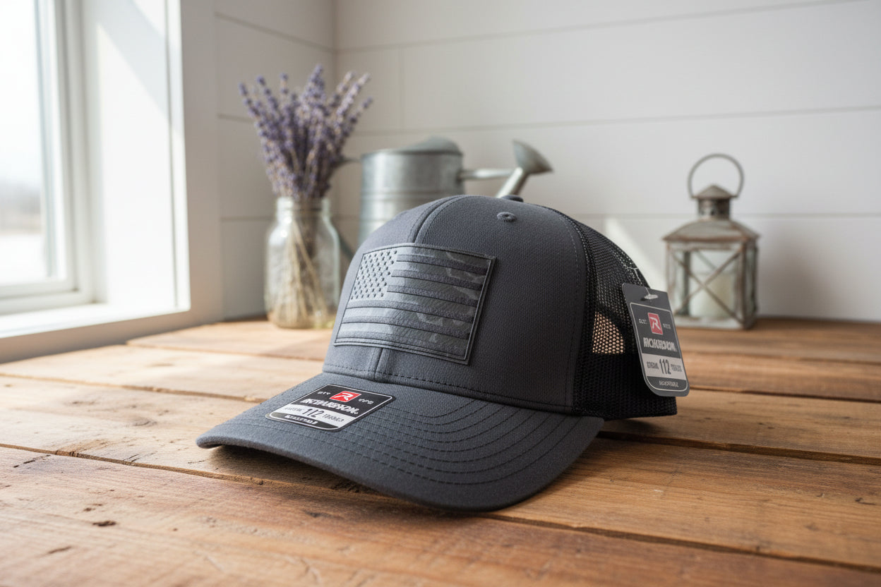 Black trucker hat with American flag patch and Richardson logo on a white surface.