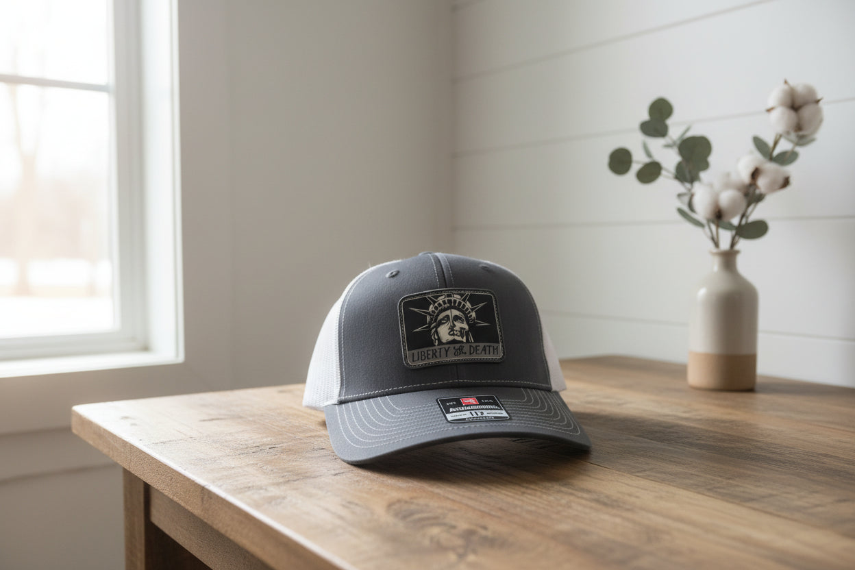 Black and white cap with a logo on a wooden surface