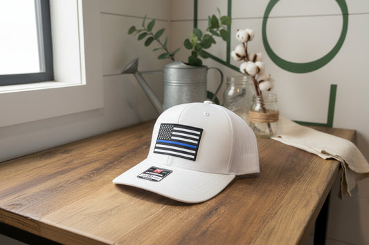 White cap with American flag patch on a wooden surface